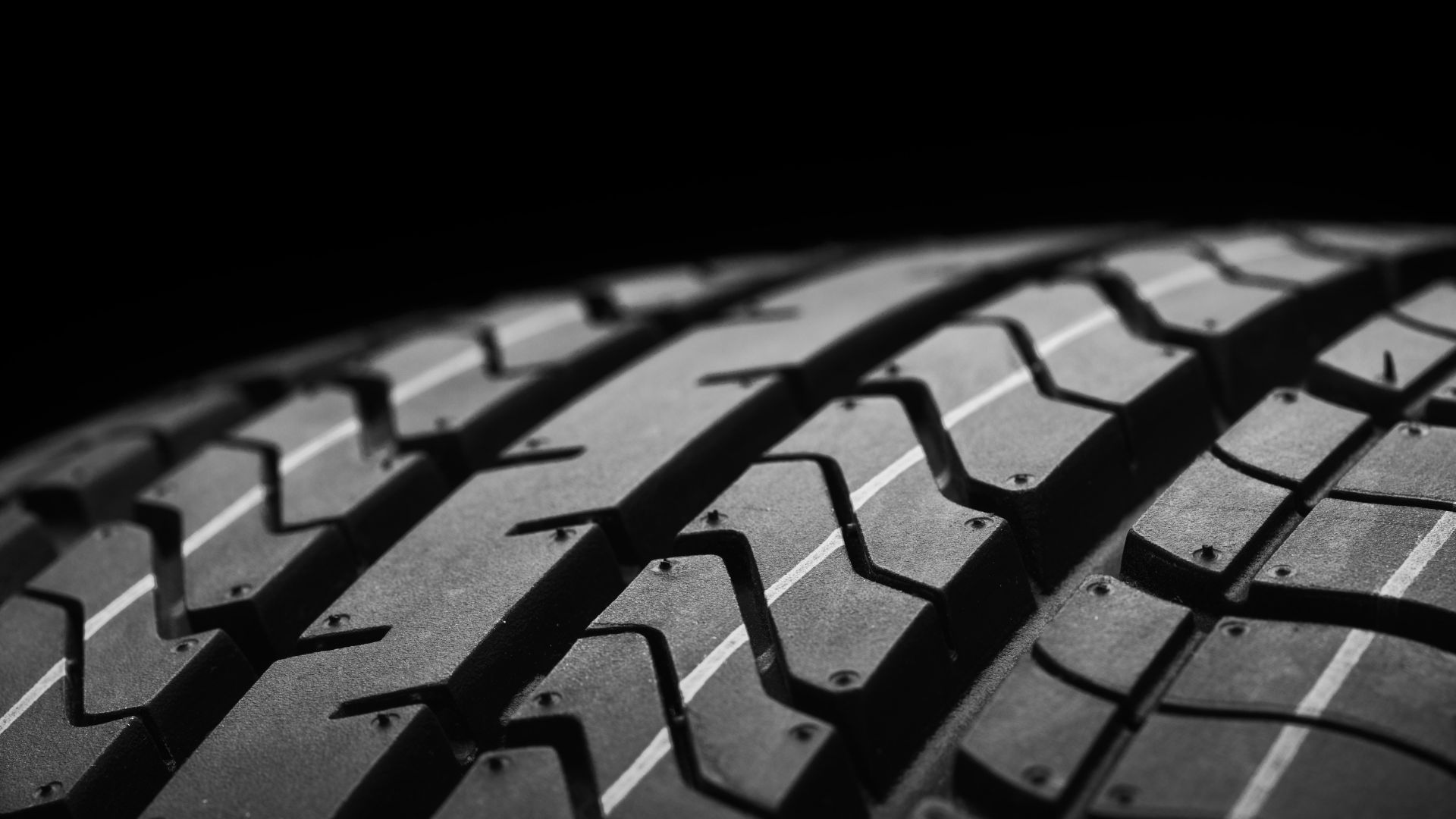 Close-up of tire tread pattern in black and white