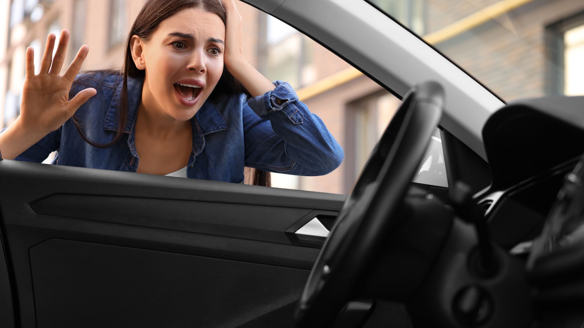 Shocked woman looks into car window with hand raised in surprise